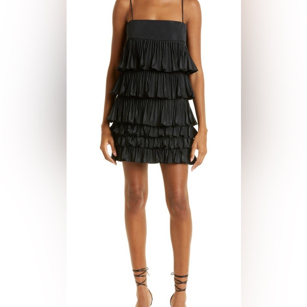Alexis Corsini.Designed with slinky spaghetti straps and floaty layered ruffles.